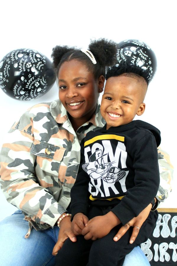 A smiling mum and her son at his birthday